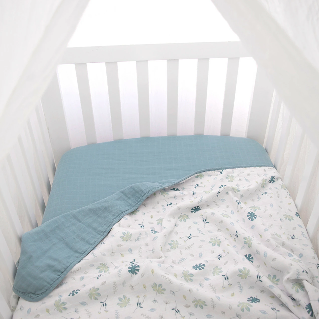 Organic Muslin Cot Blanket Banana Leaf/Teal 7 Organic Muslin Cot Blanket Banana Leaf/Teal - Image 5